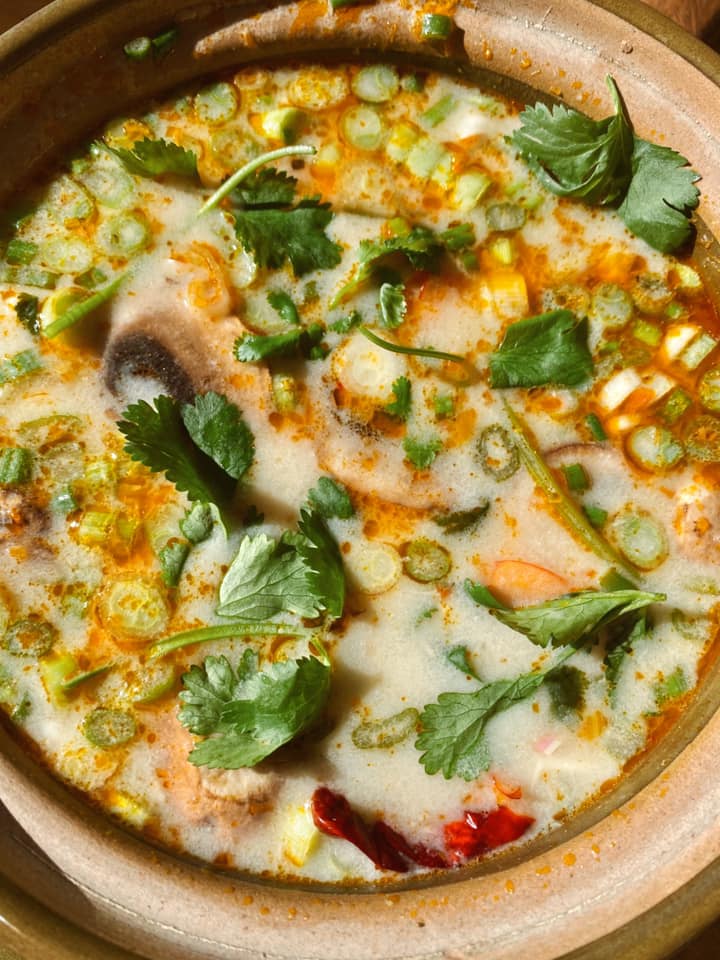 Close up of tom kha soup cooked in a campervan