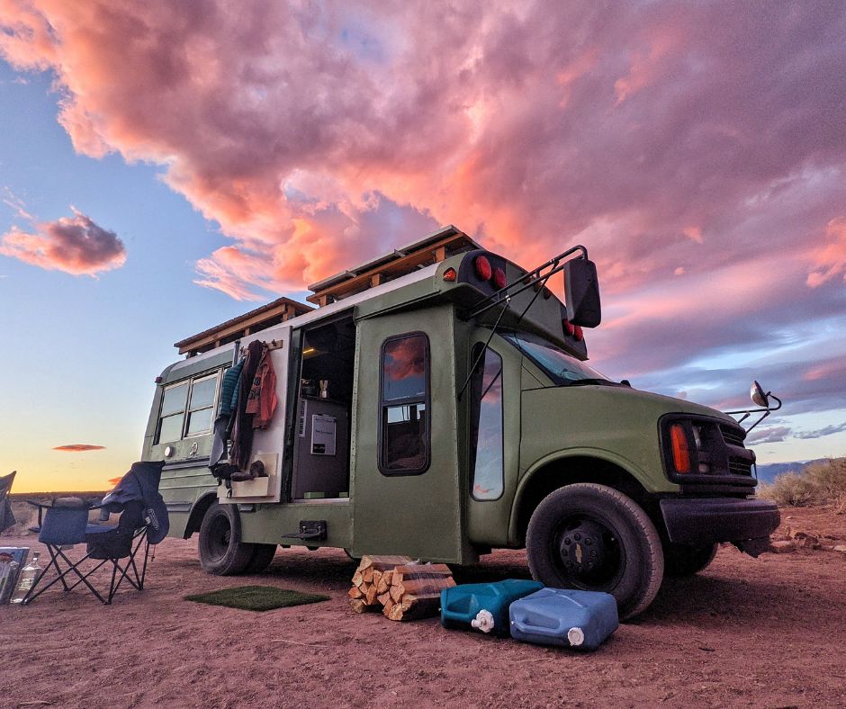 The bus framed by a beautiful pink cloudy sky