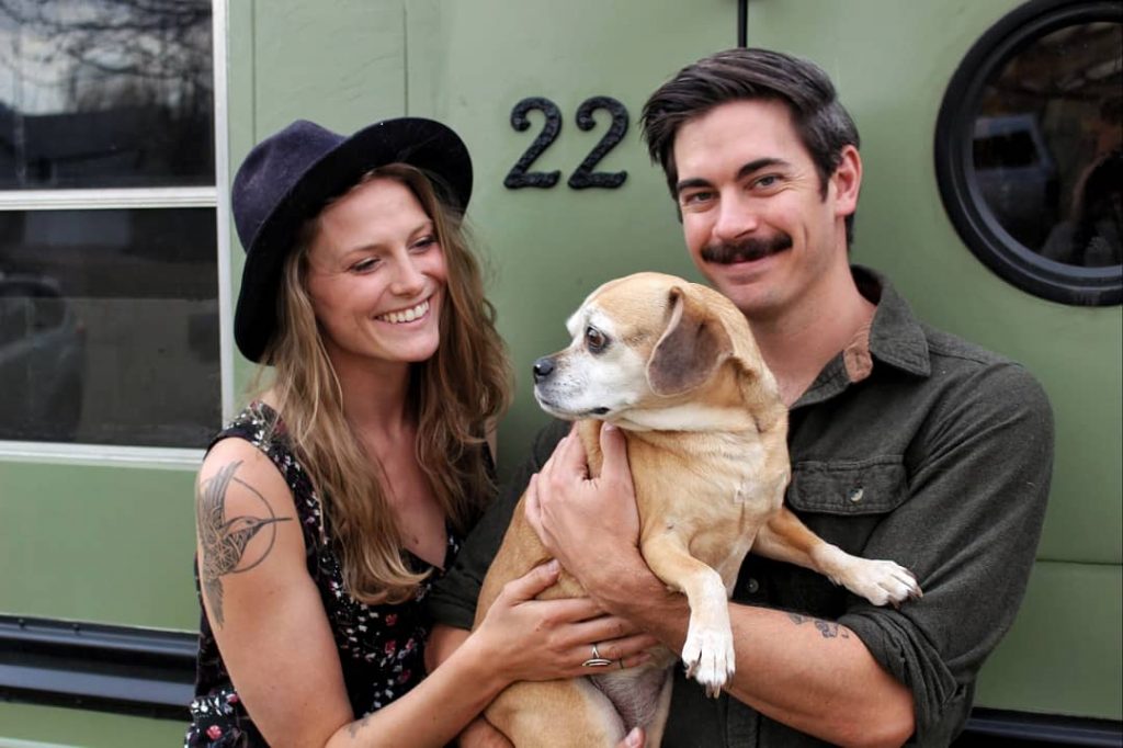 Andy and Ayana with Tori the puggle outside the bus