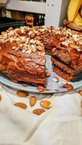 Close up view of 3 layered gingerbread cake, sandwiched with plum jam