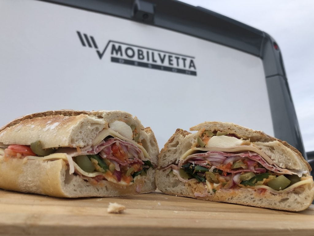 filled sandwich in front of a motorhome
