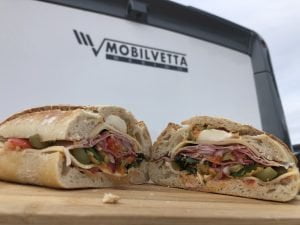 filled sandwich in front of a motorhome